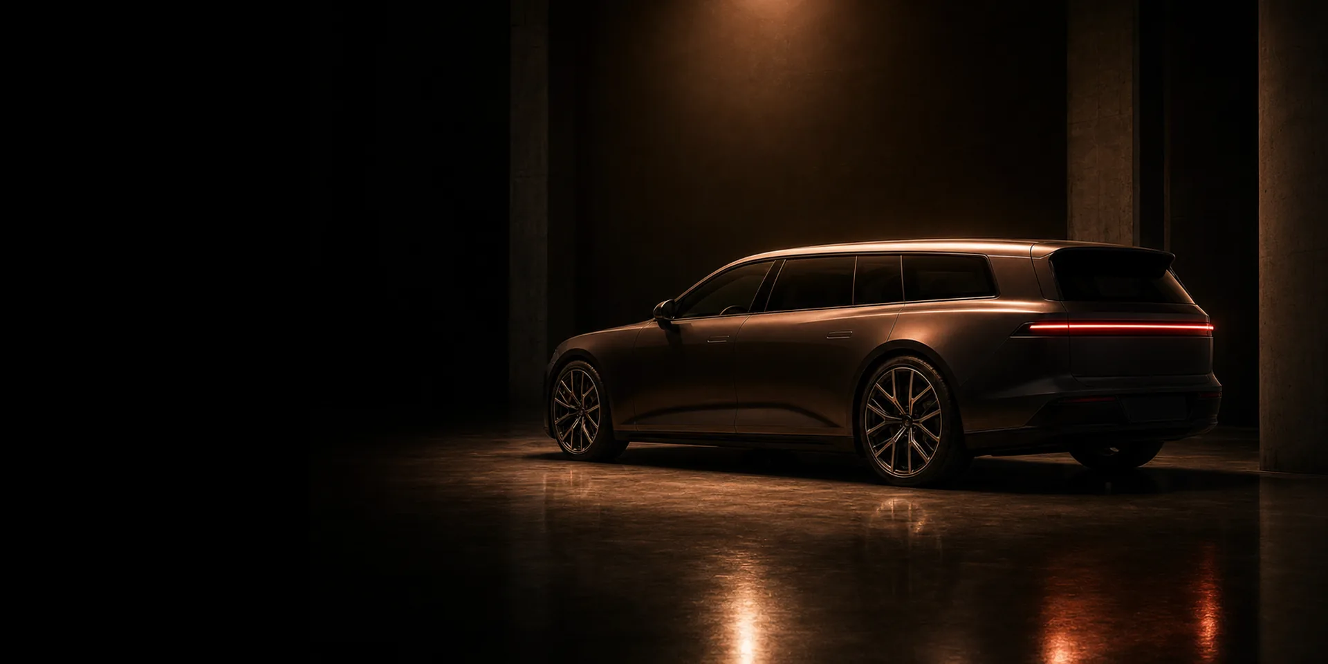 A performance EV sport estate silhouetted under a single copper spotlight in a dark showroom bay